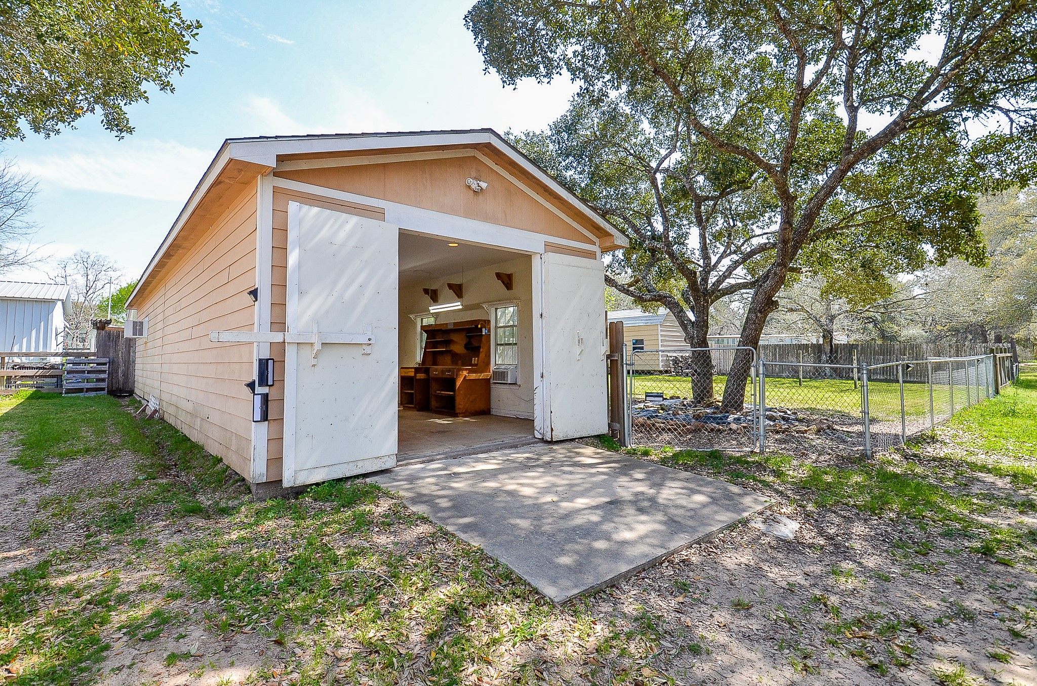 5440 7th Street Sheridan, TX 77475 - Photo 37 of 37 a view of a house with a yard and a large tree