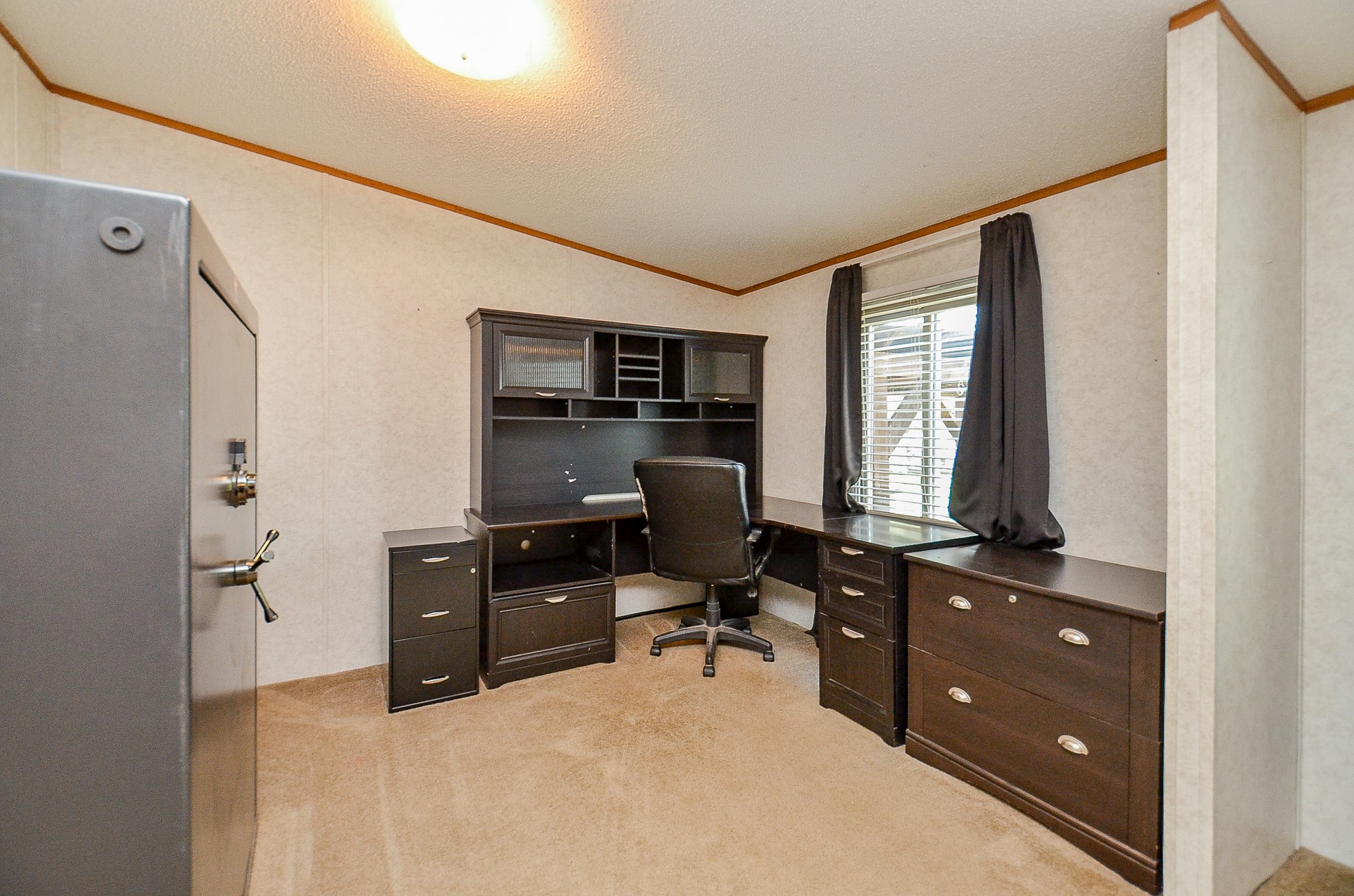 5440 7th Street Sheridan, TX 77475 - Photo 4 of 37 a view of a workspace with furniture and a window