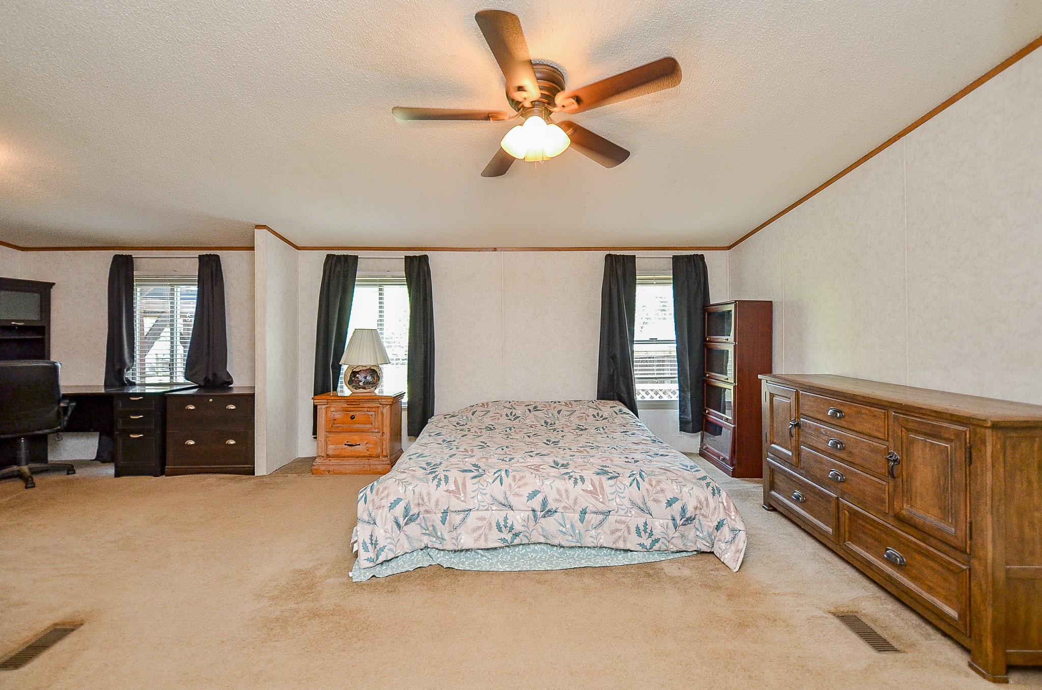 5440 7th Street Sheridan, TX 77475 - Photo 5 of 37 a bedroom with a bed dresser and wooden floor