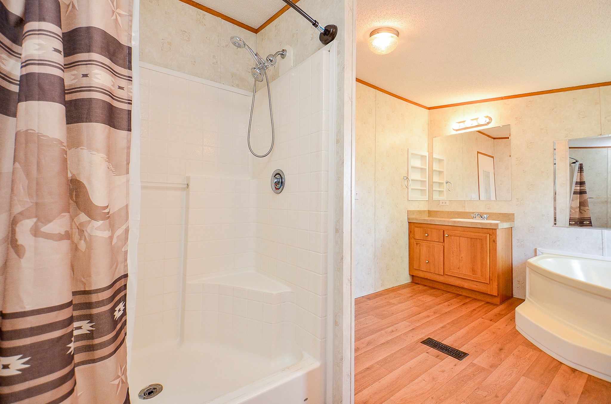 5440 7th Street Sheridan, TX 77475 - Photo 9 of 37 a bathroom with a bathtub and a shower
