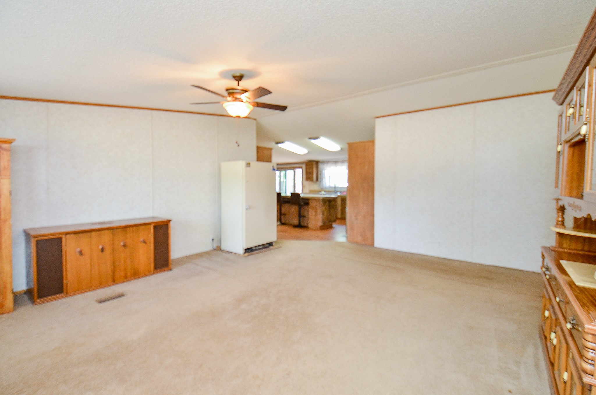 5440 7th Street Sheridan, TX 77475 - Photo 10 of 37 an empty room with a empty space and a ceiling fan