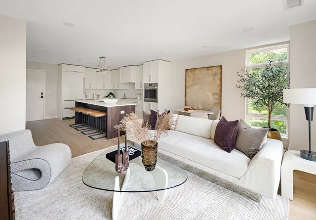 a living room with furniture a fireplace and a table