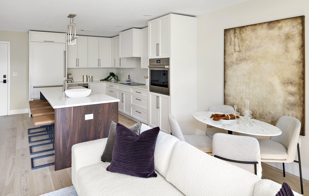 20 Kinmonth Road, Unit 201 Newton, MA 02468 - Photo 6 of 12 a living room with stainless steel appliances furniture a dining table and chairs