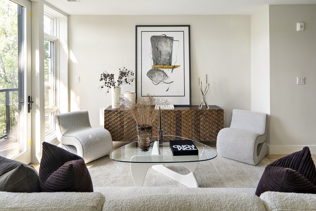 20 Kinmonth Road, Unit 201 Newton, MA 02468 - Photo 7 of 12 a living room with furniture and a large window