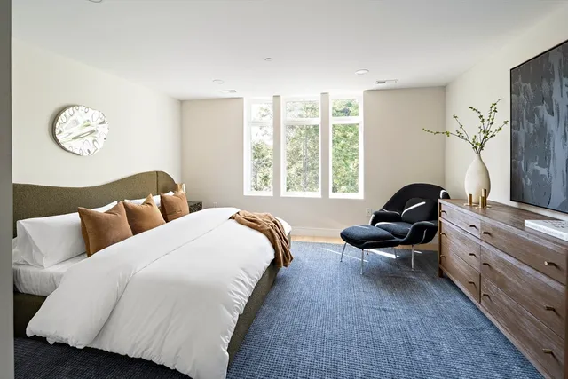 a bedroom with bed and a large window