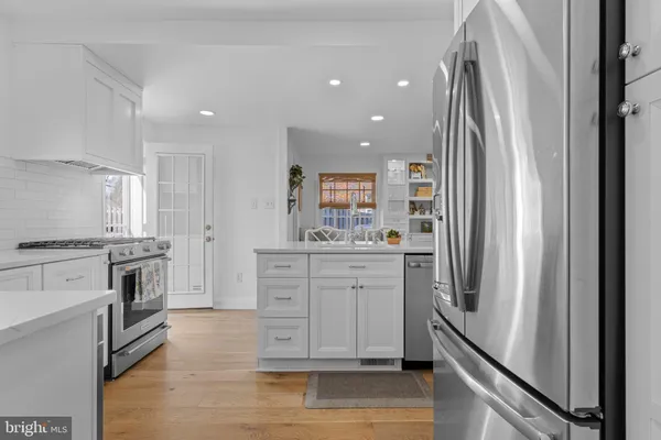 a kitchen with stainless steel appliances a refrigerator sink and stove