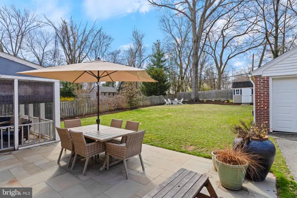 a view of a patio with furniture and a yard