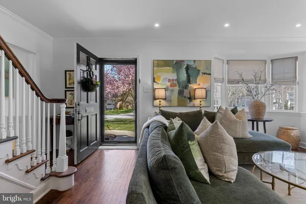 a living room with furniture fireplace and a large window