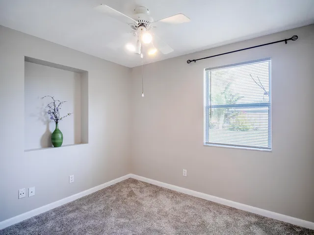 a view of a hallway with closet and a livingroom