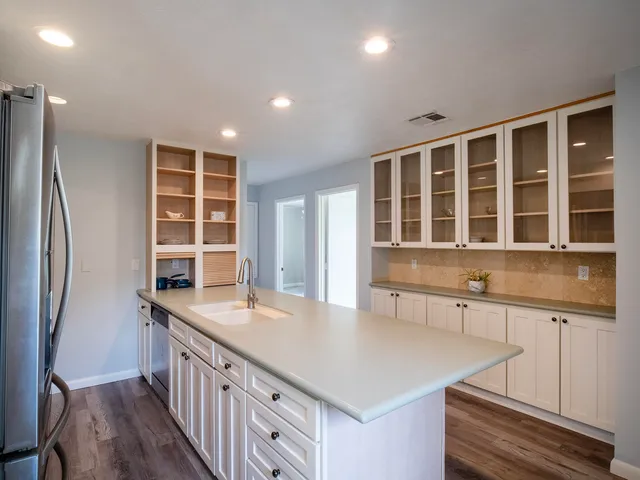 a bedroom with a large bed and a flat screen tv