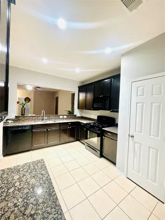 a kitchen with stainless steel appliances kitchen island granite countertop a sink and counter top space