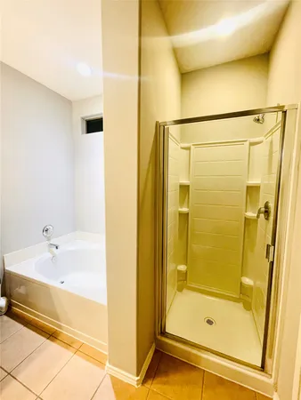 a bathroom with a shower and a tub