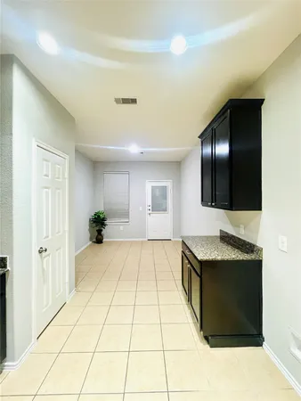 a spacious bathroom with a granite countertop sink and a mirror
