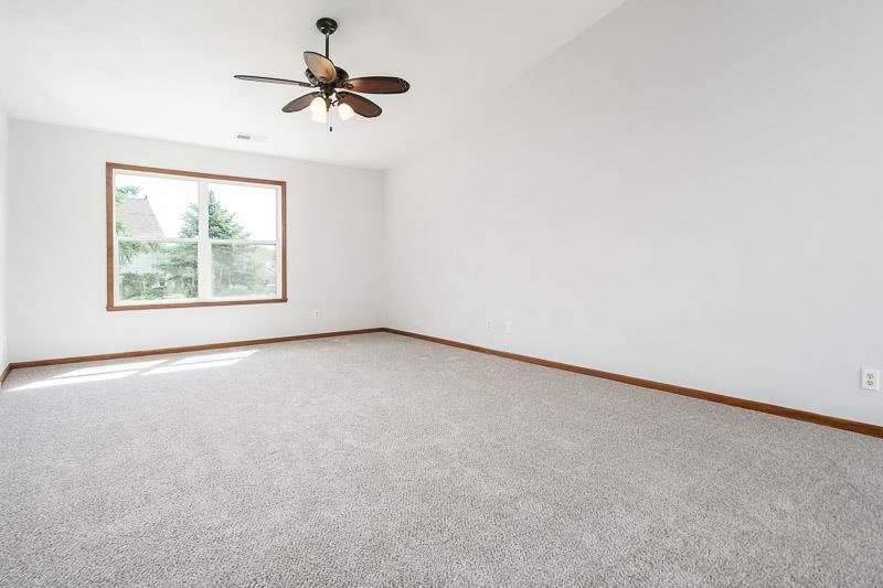 10135 Monarch Road, Unit 4 120D Roscoe, IL 61073 - Photo 6 of 26 an empty room with a window and a ceiling fan