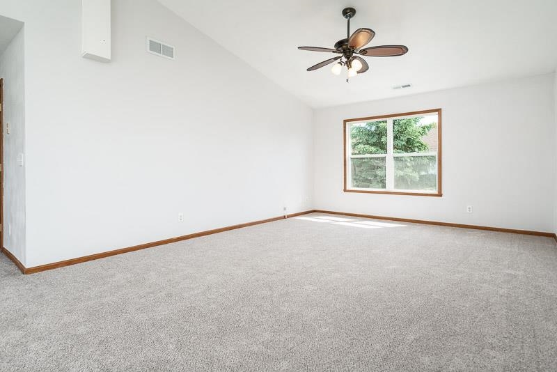 10135 Monarch Road, Unit 4 120D Roscoe, IL 61073 - Photo 8 of 26 an empty room with a window and a fan