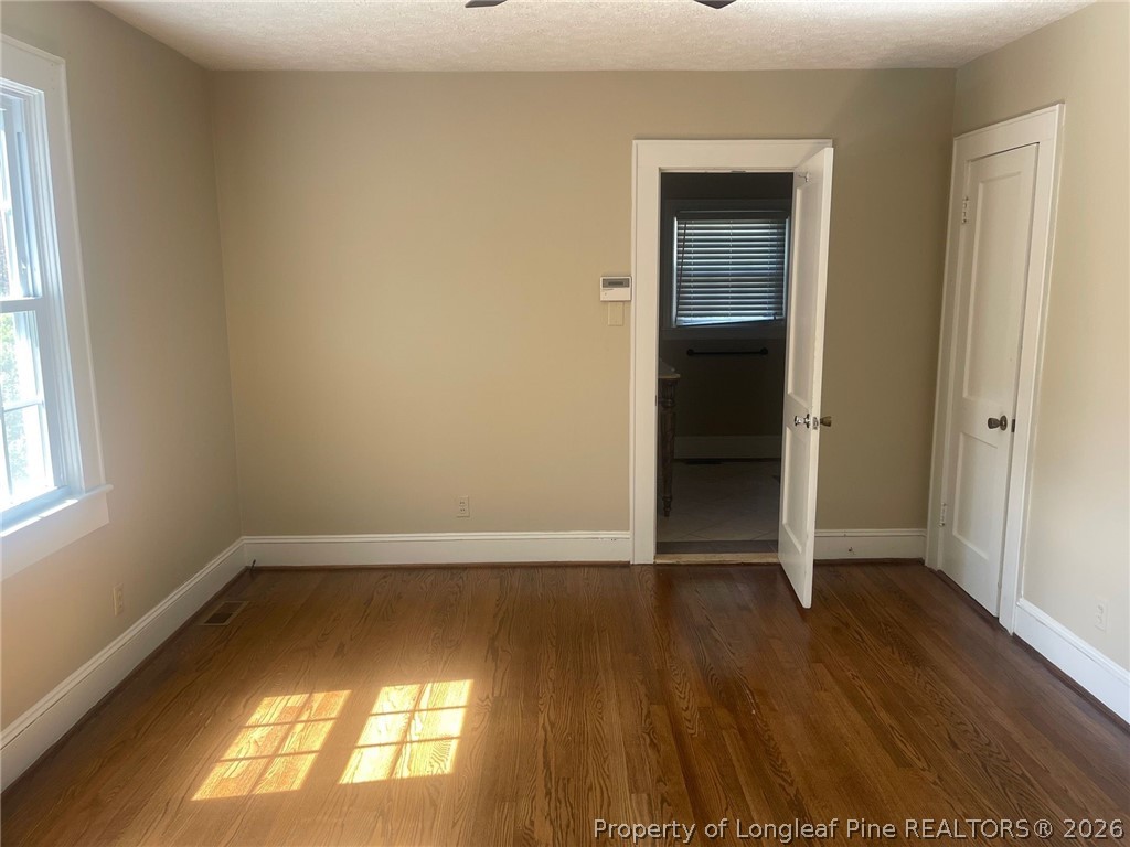 2515 Fort Bragg Road Fayetteville, NC 28303 - Photo 18 of 23 an empty room with wooden floor and windows