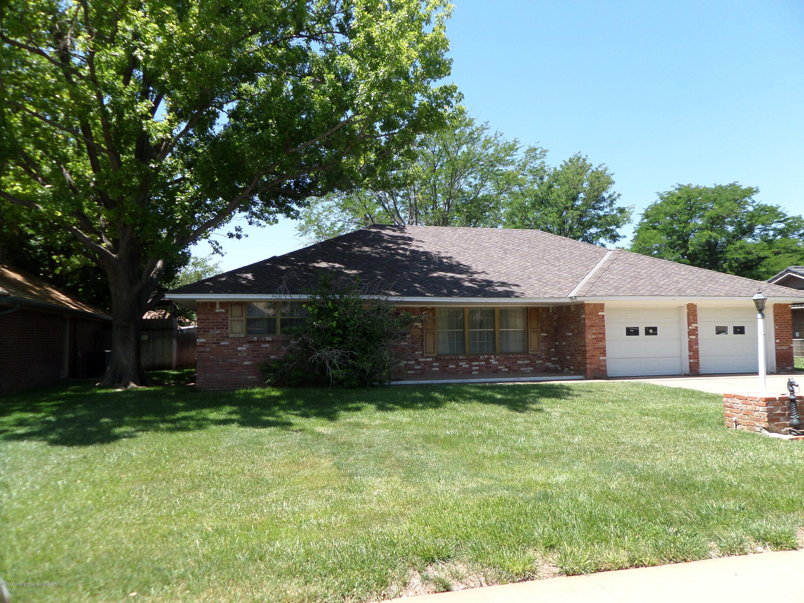 6911 Calumet Road Amarillo, TX 79106 - Photo 1 of 8 a front view of house with yard and trees