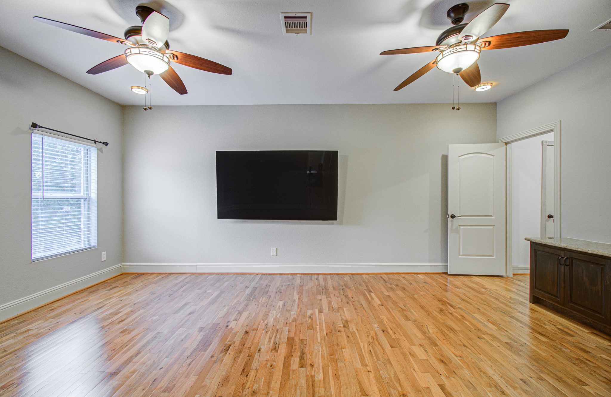 2920 Payson Street Houston, TX 77021 - Photo 42 of 50 a view of an empty room with window and wooden floor