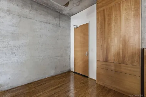 a view of an empty room with wooden floor