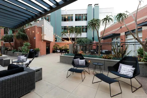 a building outdoor space with patio furniture and potted plants