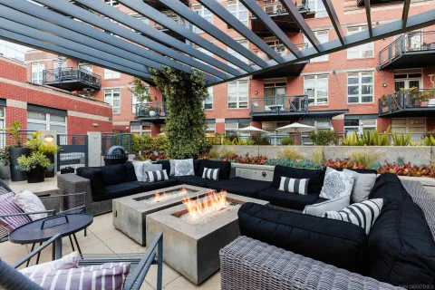 a outdoor living space with furniture and a fireplace