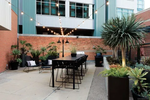 a view of a house with backyard and sitting area