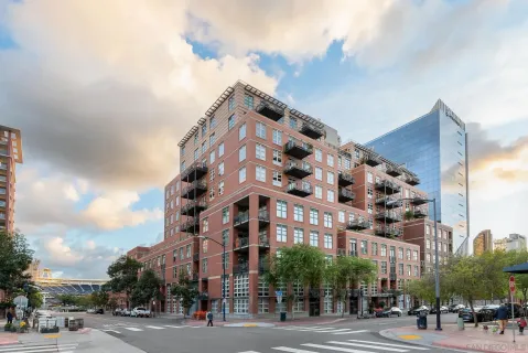 a view of a tall building next to a road