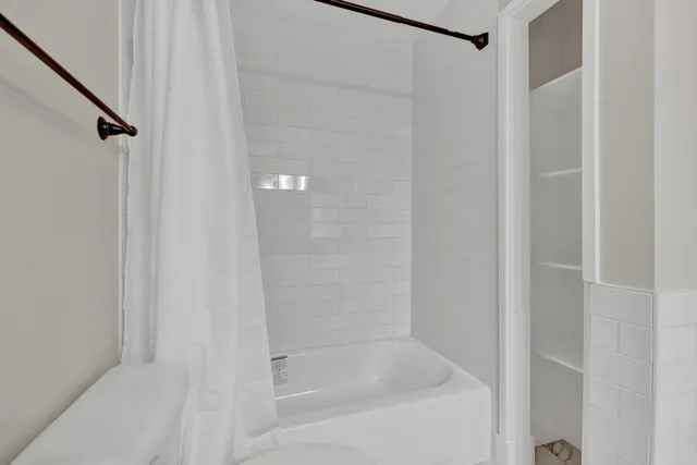 a close up of a bathtub curtain