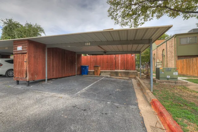 a view of a backyard with a large tree