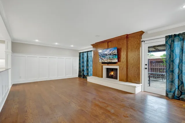 a view of an empty room with a fireplace and a window