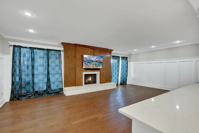 a view of an empty room with a fireplace and a window