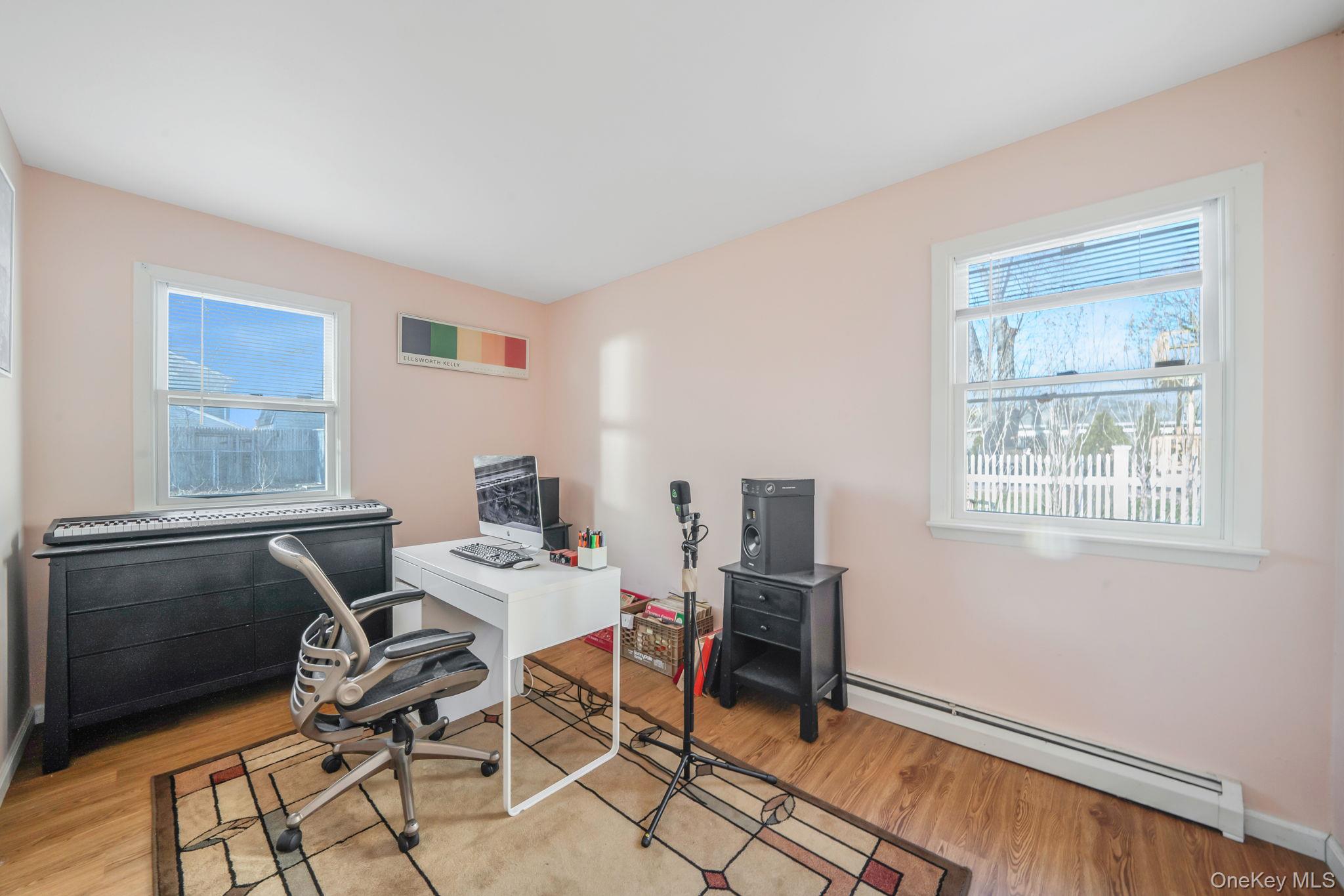 39 Kay Road Calverton, NY 11933 - Photo 11 of 17 Office with a baseboard heating unit, plenty of natural light, and wood finished floors