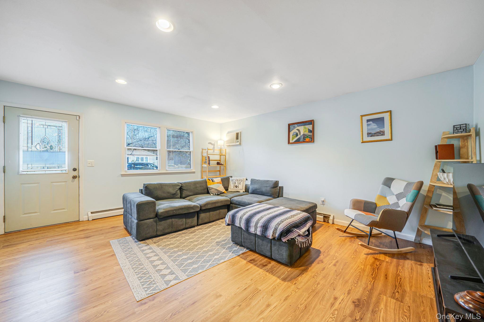 39 Kay Road Calverton, NY 11933 - Photo 5 of 17 Living room featuring light wood-type flooring, recessed lighting, and a baseboard radiator