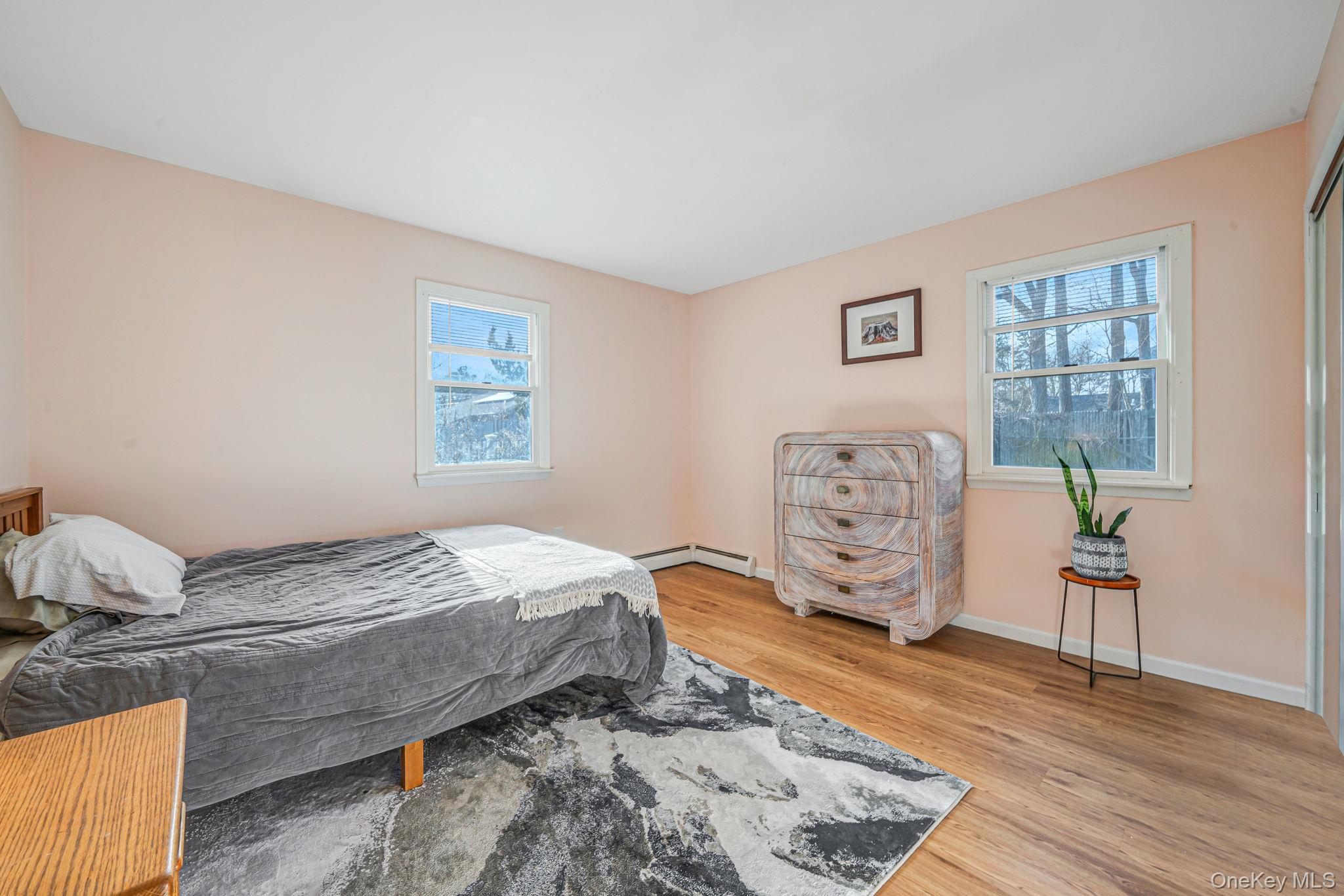 39 Kay Road Calverton, NY 11933 - Photo 10 of 17 Bedroom featuring light wood-style flooring and multiple windows