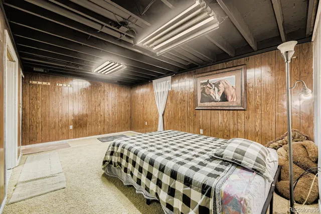 a bedroom with a bed next to a window