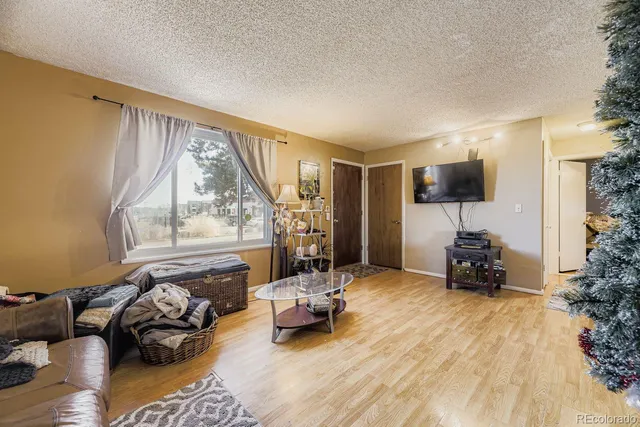 a bedroom with furniture and a large window