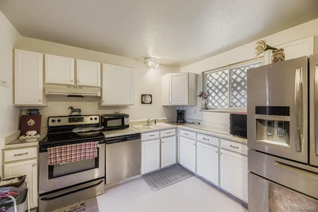 a kitchen with a sink stove and cabinets