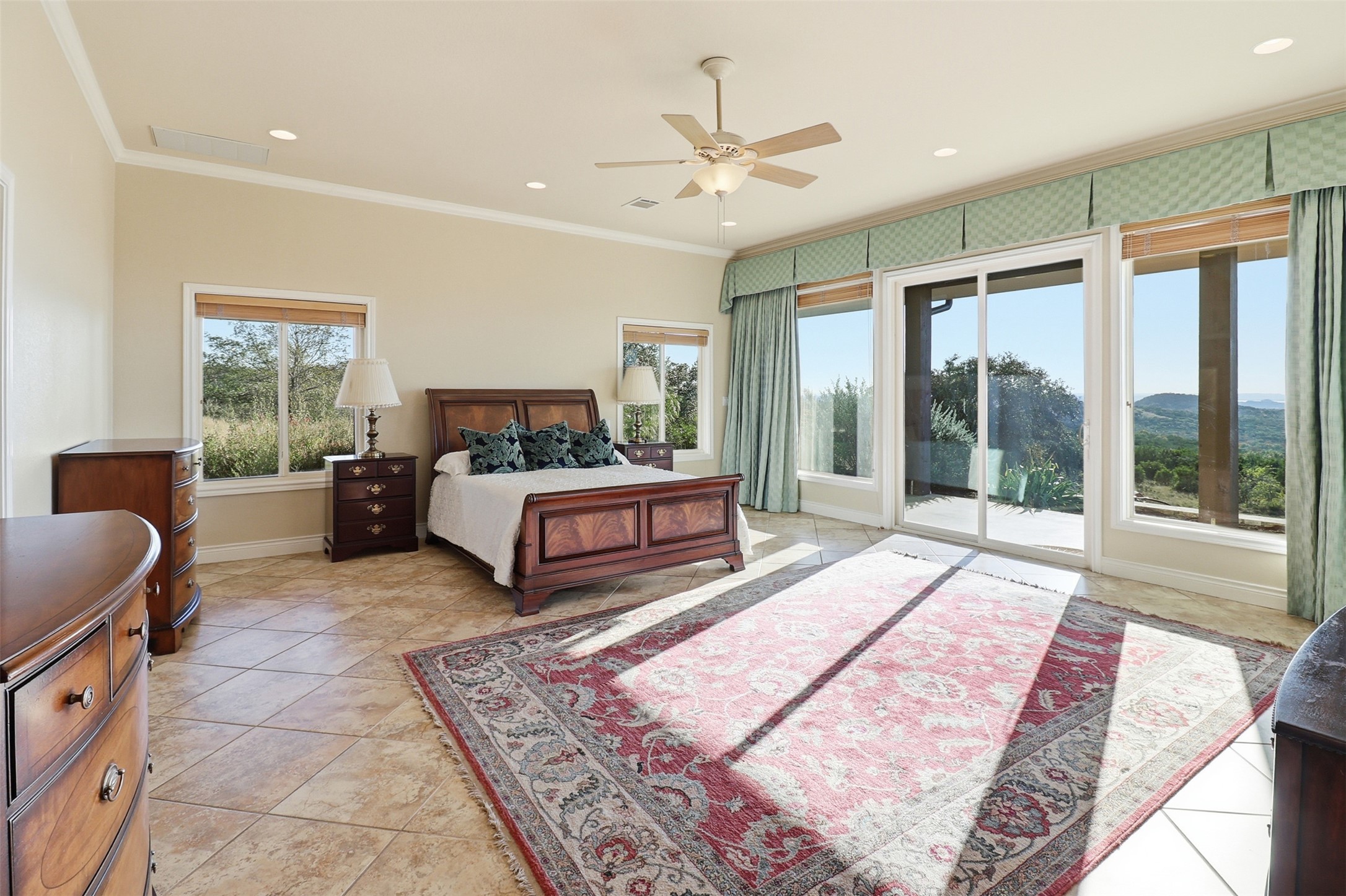 450 Threadgill Ranch Road Burnet, TX 78611 - Photo 8 of 33 a spacious bedroom with a large bed and a large window