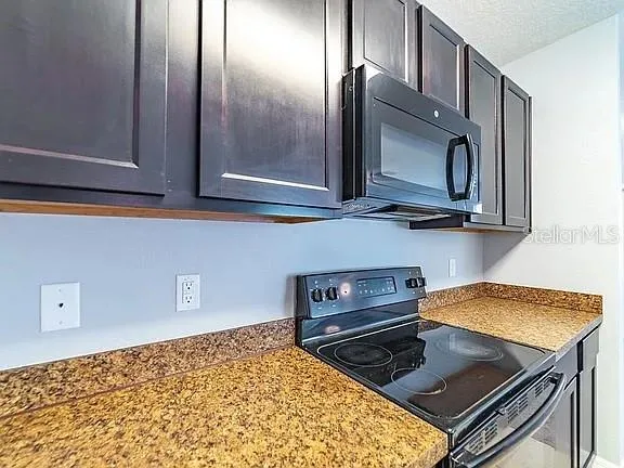a kitchen with a stove and a microwave