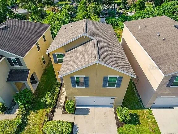 an aerial view of a house with a yard