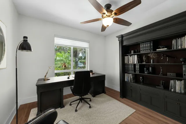 a view of a workspace with furniture and a bookshelf