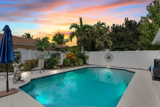 a view of a swimming pool with a yard