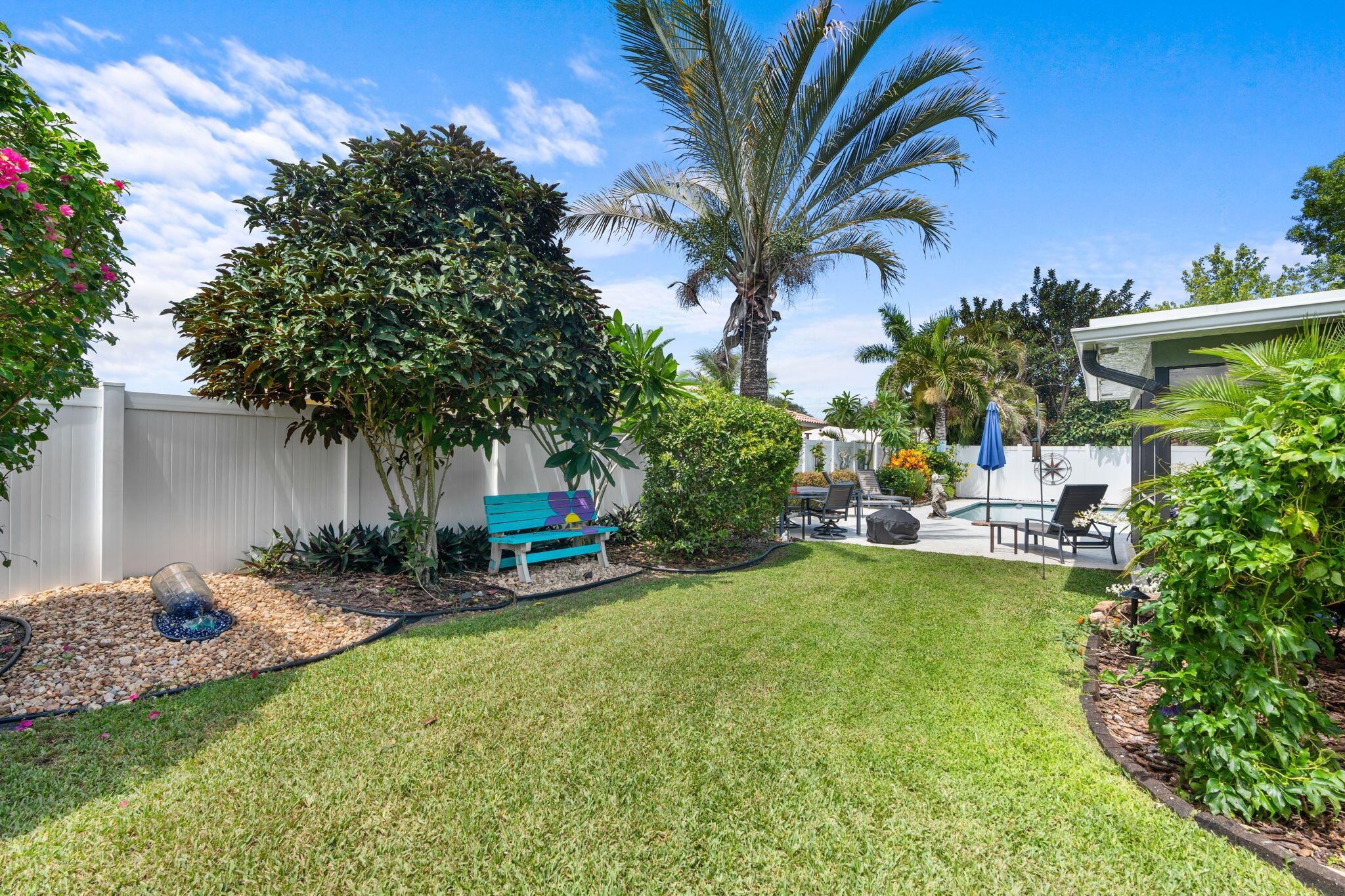 2529 Northwest 32nd Street Boca Raton, FL 33434 - Photo 16 of 19 a backyard of a house with table and chairs and potted plants