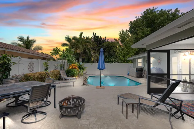 a swimming pool with outdoor seating and yard