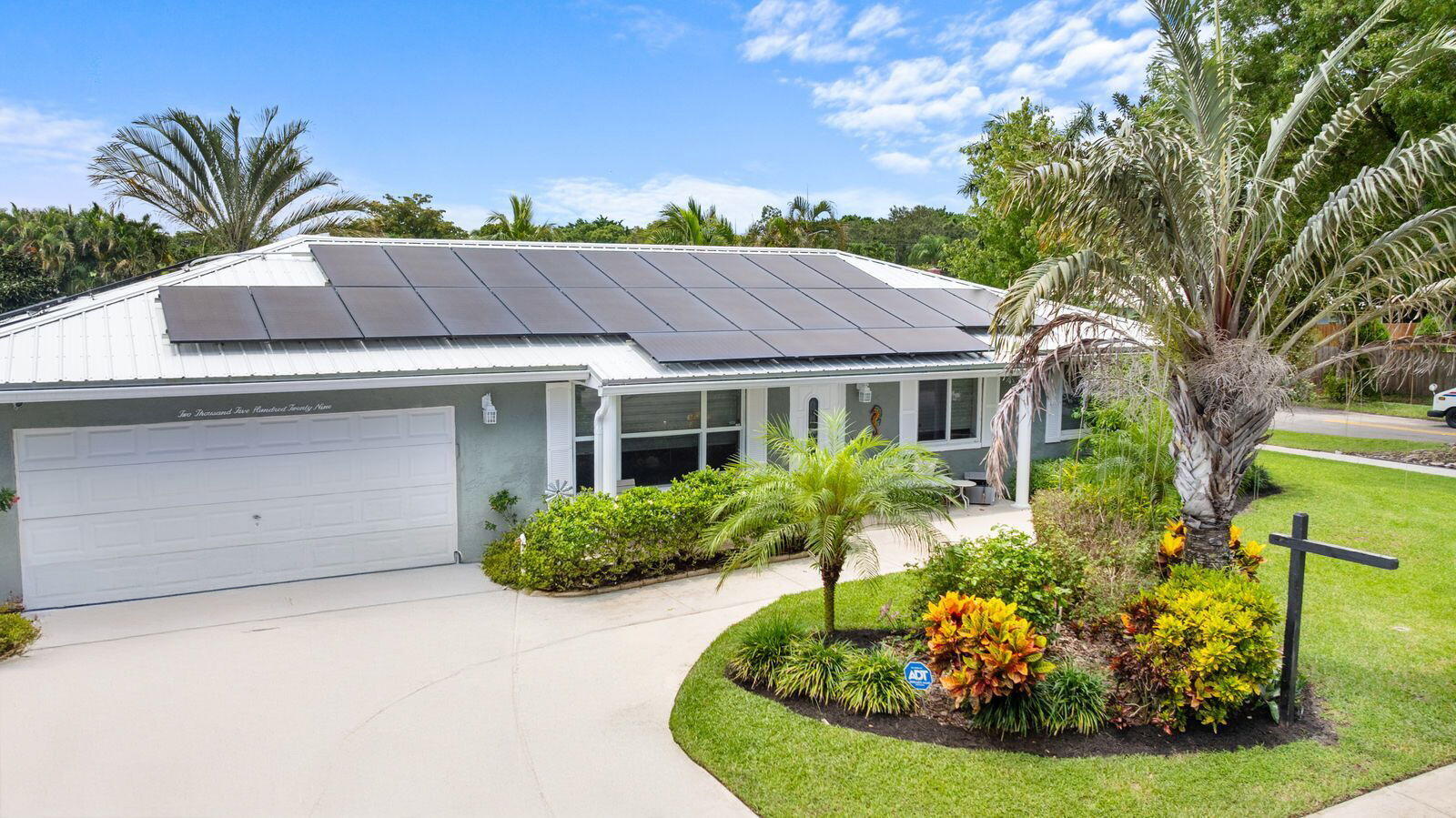 2529 Northwest 32nd Street Boca Raton, FL 33434 - Photo 2 of 19 a front view of a house with a yard