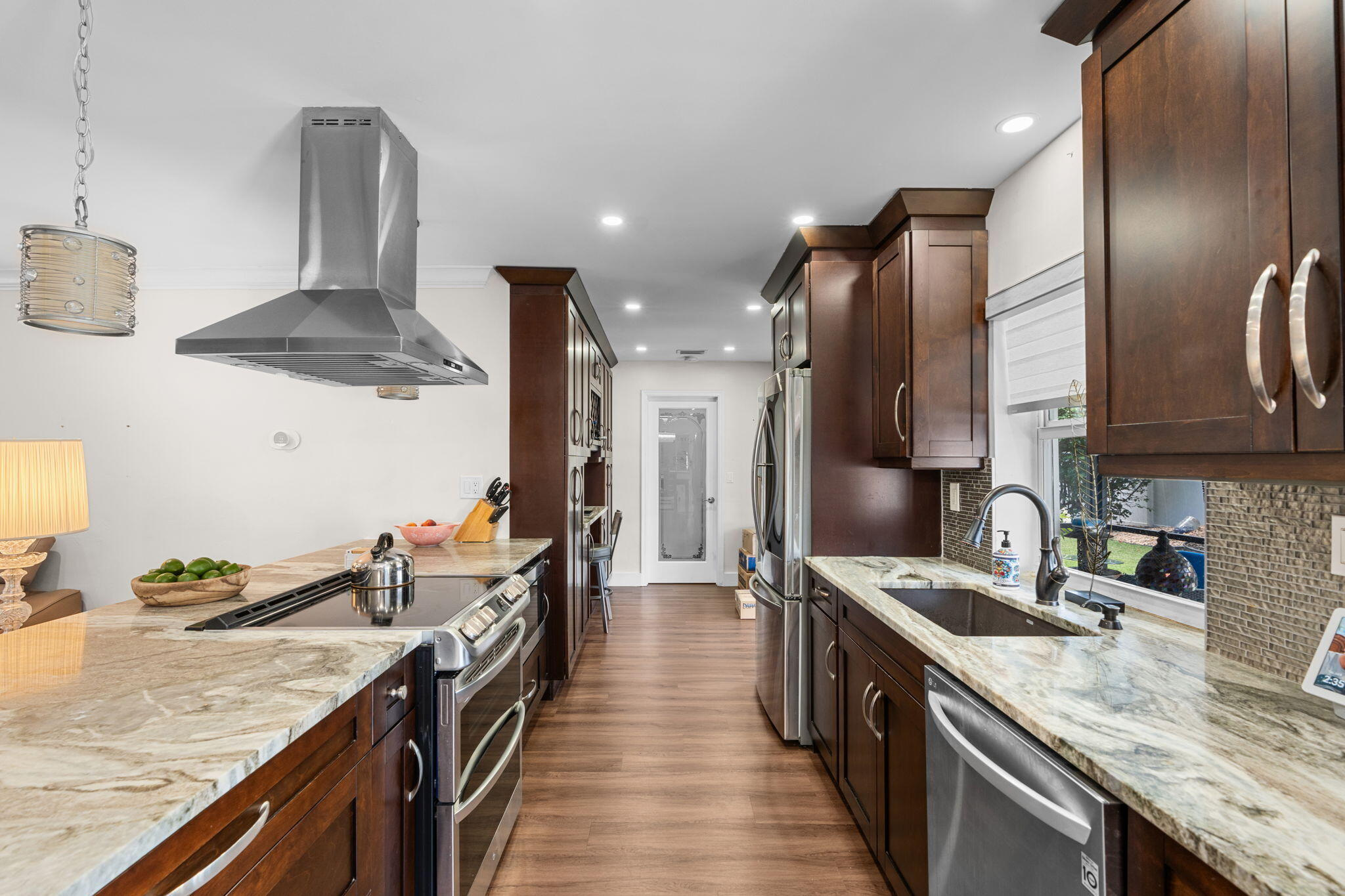 2529 Northwest 32nd Street Boca Raton, FL 33434 - Photo 5 of 19 a kitchen with stainless steel appliances granite countertop a sink a stove and a refrigerator