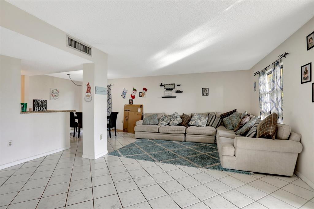 5570 Northwest 44th Street, Unit 518A Tamarac, FL 33319 - Photo 12 of 28 a living room with furniture and a couch
