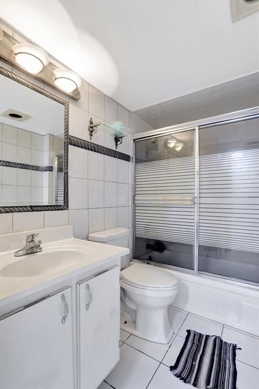 5570 Northwest 44th Street, Unit 518A Tamarac, FL 33319 - Photo 18 of 28 a bathroom with a sink toilet vanity and shower