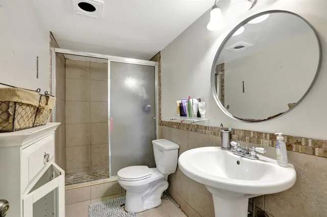 a bathroom with a sink a toilet and mirror