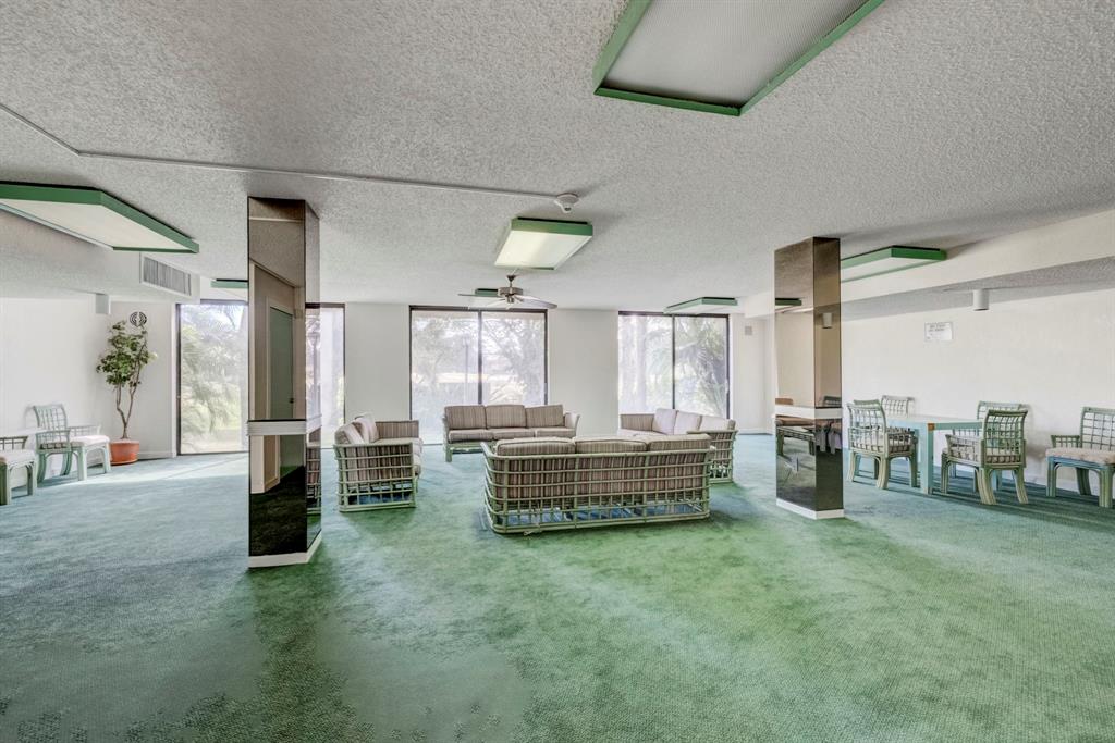 5570 Northwest 44th Street, Unit 518A Tamarac, FL 33319 - Photo 26 of 28 a living room with furniture and large windows